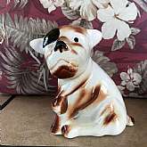 Vintage Ceramic Dog with Patch Over One Eye Brown White - 1940's. Item is it not marked but I believe it was made in Japan.  Measures 5 3/4 inches tall x 5 inches wide x 2 3/4 inches, Thi ceramic dog is brown and white with a black patch over one eye.