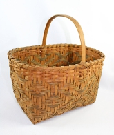 This handsome single-weave Cherokee basket was twill plaited of white oak splints circa 1960's. It's called a market basket; its uses included storing grain, catching fish and carrying food. Over the last century, weaving patterns have been named for the 