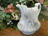 Rare elegant pitcher by E.P.P. Co.  - East Palestine Pottery Company - made in East Palestine, Ohio, USA 
White porcelain, floral transfer, gilt trim antique water pitcher made between 1891 and 1903.

