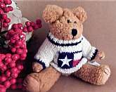 Adorable beige stuffed plush bear by Berkeley Designs. Nubbly beige jointed stuffed plush bear wearing a red, white and blue stars and stripes knitted sweater.