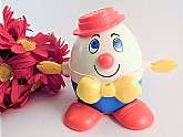 Vintage Classic Humpty Dumpty by Fisher-Price Humpty Dumpty  Model #736 push or pull toy. Humpty Dumpty has a printed face with a red nose, a red hat, yellow arms on the sides, a yellow bow tie on the front, and red shoes. Vintage 1972 model.