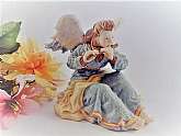 Cast resin handpainted angel figurine.  White and blue young woman angel playing the flute.