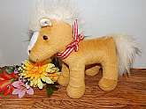 Stuffed animal pony children's toy, a beige horse with white tail and mane.