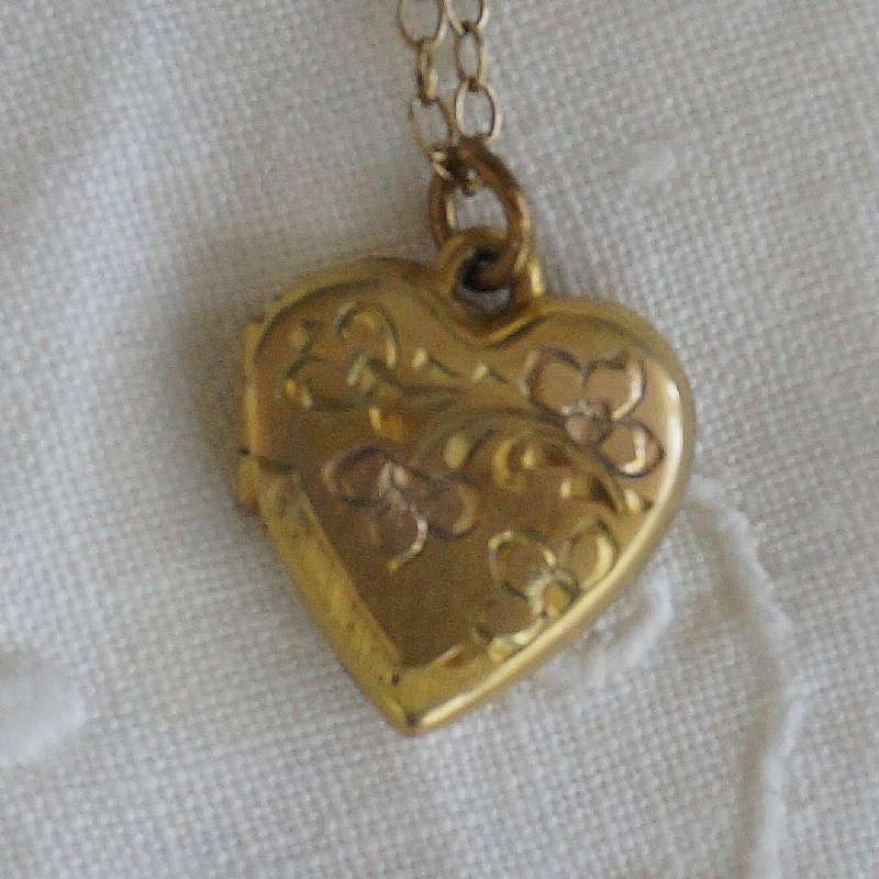 Beautiful vintage gold filled engraved heart flower locket that measures 1/2 inch and is hung on a dainty 15 1/2 inch chain.  The locket is engraved with a flowers and leaves on the top.  It is the perfect classic edition for any bride on her wedding day