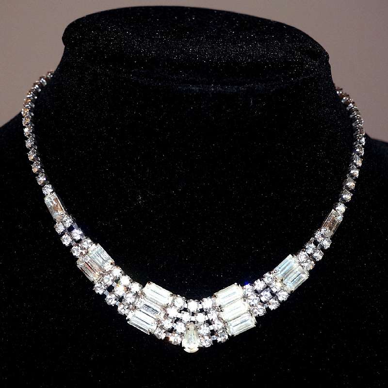 Beautiful vintage Kramer prong set chaton & baguette rhinestone necklace that sparkles like crazy.  It has a graduated design that starts out with a single strand and turns into 4 strands at the middle with baguette rhinestone spacers.   It measures 3