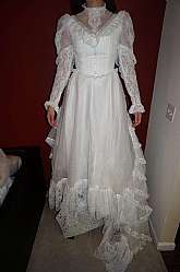 Amazing vintage Victorian or Edwardian style wedding dress with high neck and tiered ruffles.  The dress is made of floaty chiffon fabric with lace accents and puffed sleeves.  This dress is so elegant and beautiful on.  It is about a size 4/6 and measure