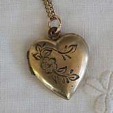 Beautiful vintage gold filled engraved heart flower locket that measures 7/8 inch and is hung on an 18 inch  link chain.  The locket is engraved with a flowers and leaves on the top.  It is the perfect classic edition for any bride on her wedding day and