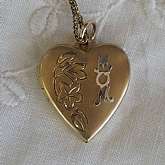 Beautiful vintage gold filled engraved heart "MOM" locket that measures 7/8 inch and is hung on an 18.5 inch  link chain.  The locket is engraved with a flowers and leaves with the word MOM on the top.  It is the perfect classic edition for any