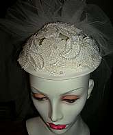 Beautiful vintage flower lace headpiece cap and veil made in the late 80s early 90s.  The cap has cutout floral bridal lace that has been embellished with sequins and pearl beads.  The veil is 5 tiered, has a ruffled top and measures about 19 inches from