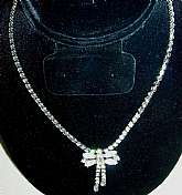 Beautiful vintage prong set rhinestone chain necklace with what sort of looks like a butterfly dangle.  This is probably from the 30s or 40s and is very well made with a rhinestone fold over clasp.  It measures 15 3/4