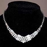 Beautiful vintage Kramer prong set chaton & baguette rhinestone necklace that sparkles like crazy.  It has a graduated design that starts out with a single strand and turns into 4 strands at the middle with baguette rhinestone spacers.   It measures 3
