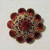 Beautiful vintage 3 layer Siam ruby red rhinestone filigree pin.   The pin has all prong set stones and is very well made.  It measures 1 1/2