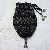 Gorgeous large antique Victorian or Flapper era micro beaded cut steel drawstring reticule or handbag in lovely black and silver with black silk lining. The bag is original and in wonderful overall condition with the exception of some rusty beads in sever