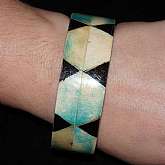 Unique wood bracelet that has inlaid dyed coral that has been dyed aqua on some parts.   It is a wider bangle, very unique and sure to get compliments.