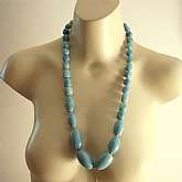 Super huge vintage artisan free form amazonite bead necklace that is 30 inches long.  The beads graduate in size up to 1 3/4 inches and are very high quality.  We thought it was high quality larimar but believe it to be amazonite.  It has a sterling silve