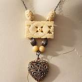 Fabulous one of a kind necklace made from a combination of vintage parts.  There is a wonderful antique carved bone flower piece with bronze tone vintage flower heart pendant on a bronze tone vintage chain. It is sweet and charming with not too much and n