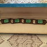 Wonderful vintage faux jade or jadeite filigree link bracelet with beautiful carved cabochon art glass.  It measures 7 1/2 inches long by almost 3/4 inches wide.  It is absolutely gorgeous in hand and much more beautiful than the photos portray.