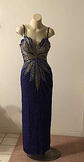 Stunning vintage formal beaded sequined Hollywood Cher worthy formal evening gown by the fabulous Ted Lapidus, Paris.  This gown hass all the bells and whistles - sure to get you some whistles too!   The dress zips up the back, has  a back slit and is bre