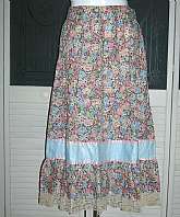 Absolutely perfect vintage boho indie hippie gypsy skirt in a beautiful multicolored floral print cotton.  It has a wide waistband and a solid pale blue band near the bottom right before the ruffled hem.  Tagged a size 14 by 70s standards and measures:  w