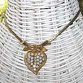 This gorgeous necklace looks like some of the early Coro Pegasus pieces. It has an elaborate and unique chain ending in a dramatic drop that is a rhinestone encrusted heart. It measures 15 1/2 inches and is in excellent condition. This is absolutely stunn