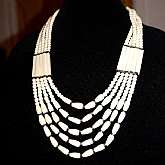 Gorgeous vintage carved ivory colored carved cow bone bead tribal necklace done in 5 amazing strands!  The necklace is comprised of 3 different handmade bone beads: round, tear drop and rectangular tubes.  There are silver tone spacers and a hook clasp.