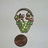 Large vintage all prong set fruit salad rhinestone flower basket brooch pin.  This is truly lovely with lots of detail and mainly done in light peridot green.  It measures 1 1/2 inches and is in fabulous vintage condtion.