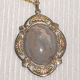 Gorgeous Antique Victorian Moss Agate Pendant Necklace in gold filled setting.  The gemstone cabochon which I am pretty sure is Moss Agate, is set in a a filigree setting.   The applied decoration looks like rose and green gold but hasn't been tested.  Th