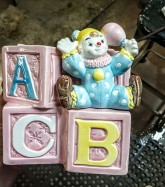 Nancy Pew designed pink planter featuring a baby clown and alphabet blocks