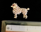 Gold tone poodle brooch with faux pearl body