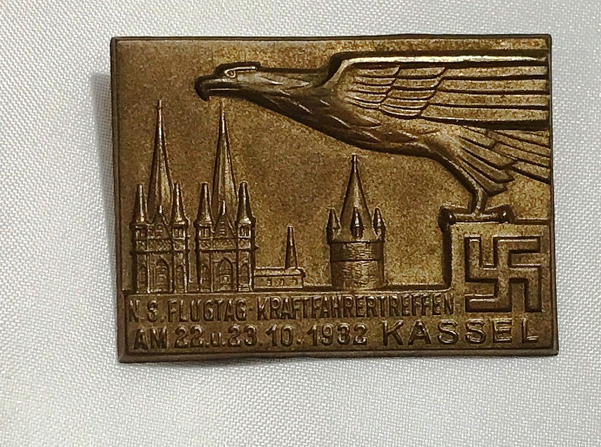 The German inscription on the tinny is "N. S. Flugtag Kraftfahrertreffen AM 22u23.10.1932 Kassel".