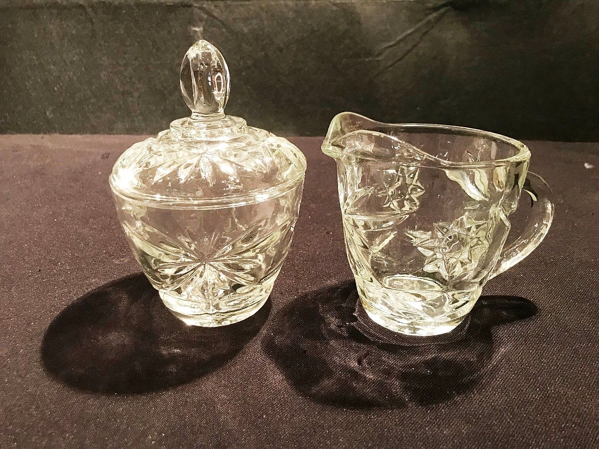 The pattern features a prominent six-pointed star (which leads to the common nickname "Star of David" among collectors) and fan motifs, designed to mimic the appearance of more expensive cut glass.