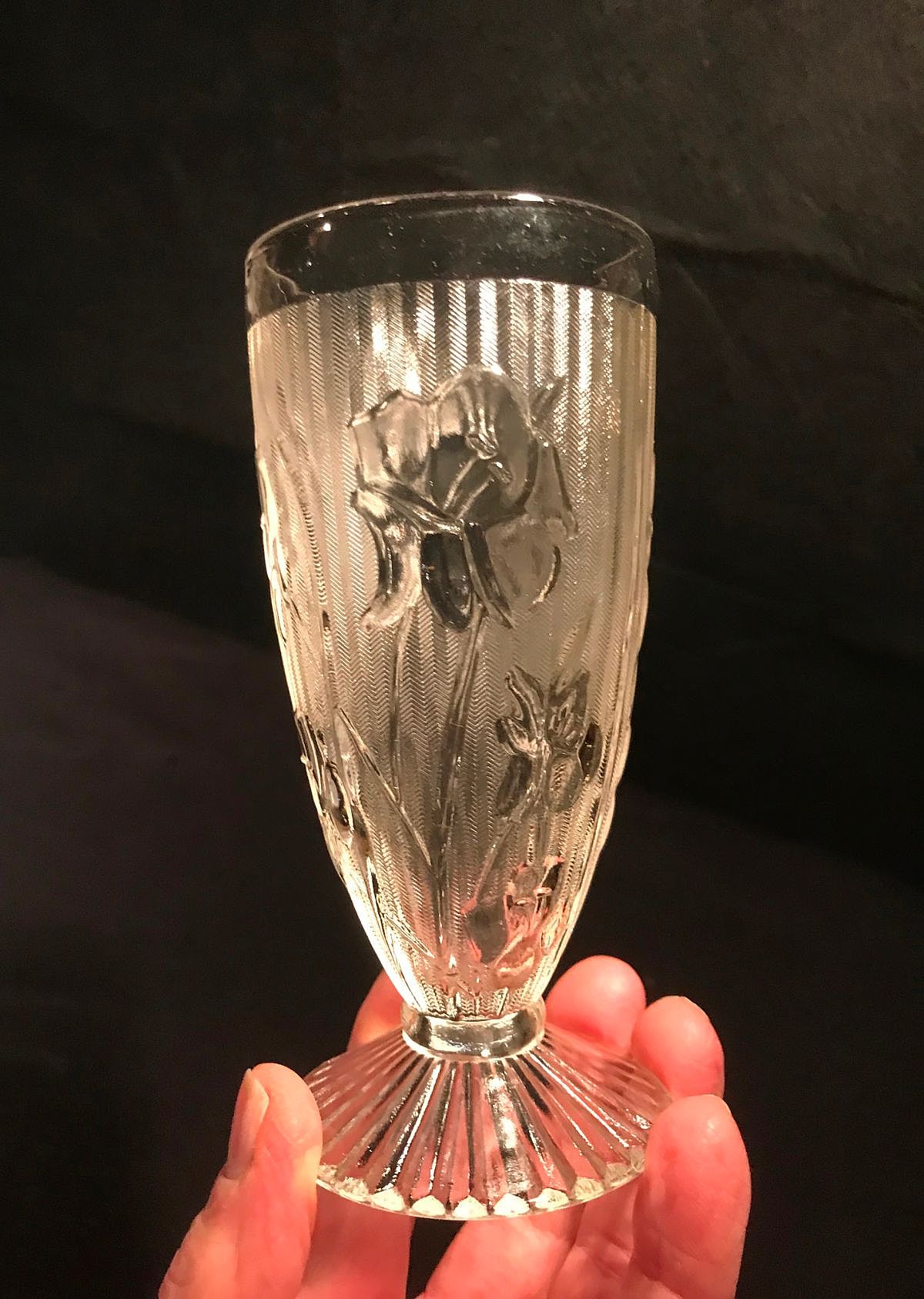 Jeannette Glass produced the popular "Iris & Herringbone" pattern as part of its Depression-era glassware, featuring an embossed iris motif against a textured background. It was originally manufactured in clear crystal from 1928 to 1932.