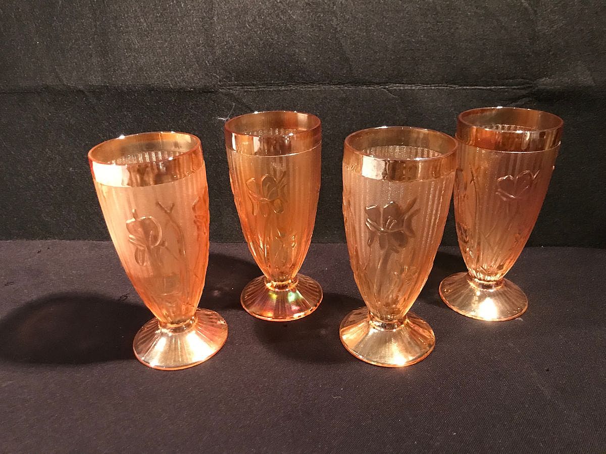 Jeannette Glass produced its popular "Iris and Herringbone" pattern in marigold iridescent, or carnival glass, primarily from the 1940s to the 1960s