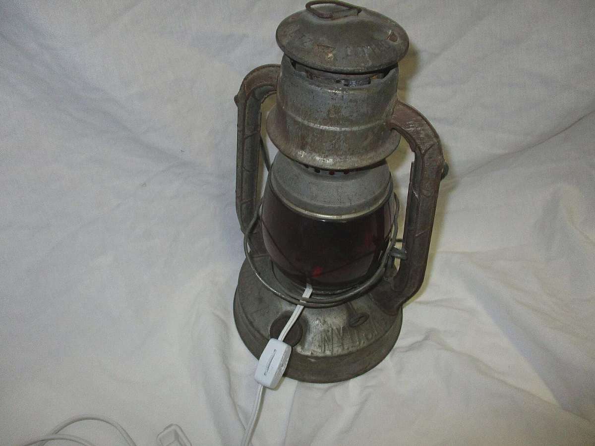 Vintage Lantern with red glass globe.In good condition and will look used. Vintage item. Power cord and light was added but you can still change back to kerosene lantern.The Vintage Dietz Little Wizard Kerosene Lantern Electric Lamp is a unique and nostal