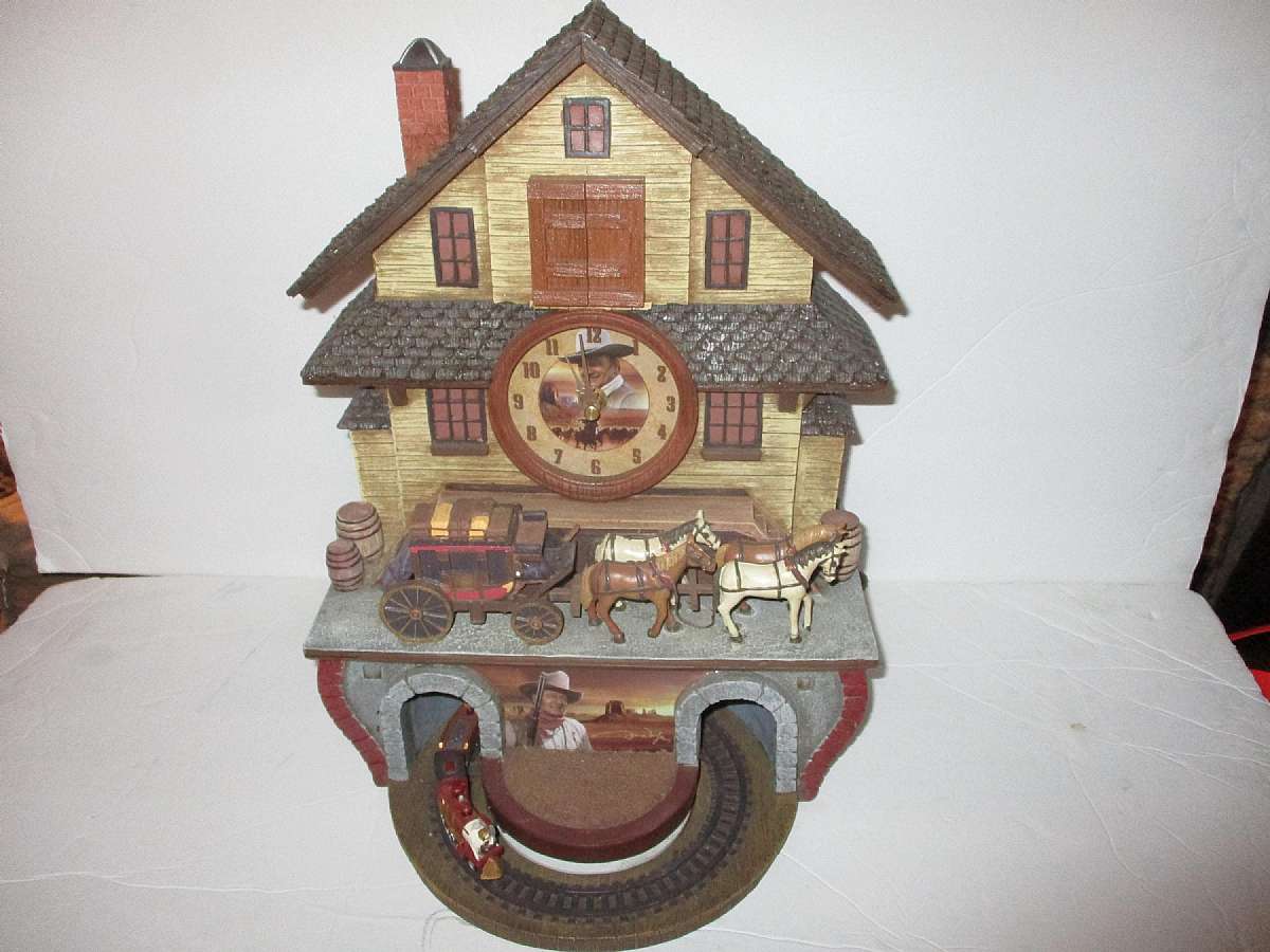 The Duke Cuckoo Clock Bradford Exchange John Wayne HorseBuggy & Train Set Rare Item.The product is a rare and unique Bradford Exchange John Wayne HorseBuggy and Train Set Cuckoo Clock. This modern style clock features a quartz movement and is powered