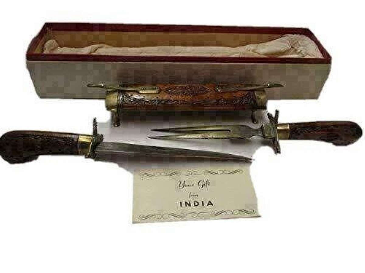 Comes in factory box.Vintage India Sword/Dagger 1 dagger with hand crafted wood handel and 1 dagger fork with hand crafted handel and they come in a Carved hand crafted wood case.The daggers blades have lubricant on them so they do not rust.In very good