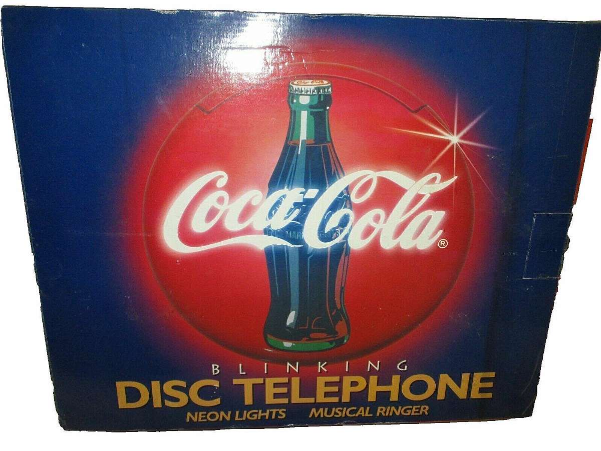 New old stock and in the original factory box.The Coca Cola Blinking Disc Telephone Neon Lights Musical Ringer is a unique collectible item that combines nostalgia with modern technology. With its red color and iconic Coca-Cola branding, it is sure to app