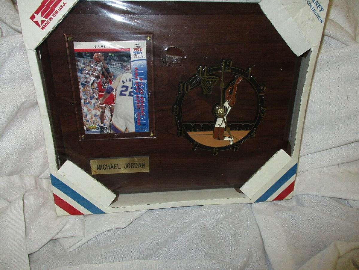 New old stock and factory sealed.The 1993 Michael Jordan Chaney Clock on Wood Wall Plaque is a unique collectible item that combines a clock with a picture of NBA legend Michael Jordan. The clock is mounted on a brown wooden wall plaque, adding a touch of