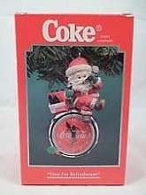Santa sitting on a clock, sipping a bottle of Coke.