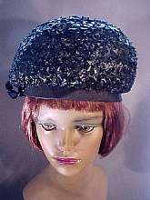 This black straw hat from the 60's has a beautiful combination of straw weaves.  It is very light and sits somewhat like a pillbox on your head. 