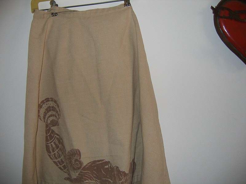 Very cute tan wrap skirt with dark brown sea shells.