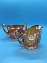 Marigold Carnival Glass Sugar & Creamer - iridescent So pretty to watch these sparkle in the light. Iridescent carnival glass is like now other. They are very peachy. Which is why when I spotted them I thought they were peach Lustreware.There are