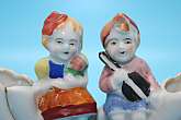 Made In Occupied Japan Vintage Boy and Girl FigurineThese are very cute. I'm not certain of what their original purpose was but I can envision them with delicate flowers in them on a sideboard or buffet.These were made in occupied Japan and hand paint