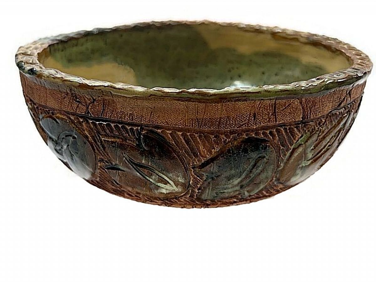 This intricately carved bowl was wheel thrown by studio potter Dawn Zaharis Prietz (1953-) in Marianna, Florida. Dawn designs unique style using stoneware clay, some of it dug locally in Jackson County.