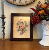 This pretty theorem painting displays the talents of artist Maura P. Campbell (1943-2023) of Hingham, Massachusetts. Using a series of stencils and oil paints in soft colors, Mrs. Campbell created a nosegay of flowers, tied with ribbon, against cream-