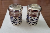   Set of round colbalt blue glass salt and pepper shakers with silver plate over accent 