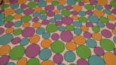   Fabric remnant with colorful polka dots that are i1in. and 2 in. size