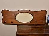 Very large wood coat rack with oval picture or mirror holder. The coat rack is approximately 29.5 inches across by 9.5 inches tall. The picture opening has a thick paper stapled to the back to hold the insert in place. Put artwork or mirror of choice in c