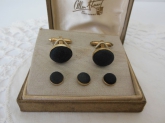black fabric in gold colored metal - cuff links and buttons in excellent to very good used vintage condition