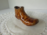 Ceramic vessel in the shape of a brown leather boot marked "Hershey Park, PA"